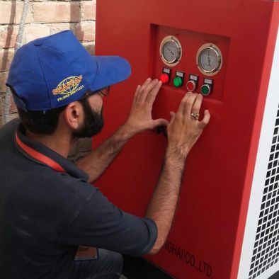 Shaffaf technician commissioning a compressor control panel
